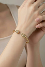 Aarvika CZ Crystal Gold Twisted Cable Panther Bracelet – flat lay