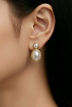 Aarvika Gold Oval Pearl Drop Earrings – model wearing