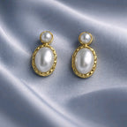 Aarvika Gold Oval Pearl Drop Earrings – flat lay