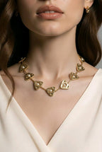 Aarvika Luxe Golden Pearl Triangle Statement Necklace – model wearing