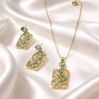 Aarvika Emerald Stone Emerald Butterfly Pendant Necklace & Earrings Set – flat lay