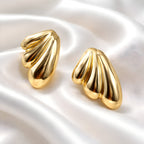 Aarvika Gold Wave Stud Earrings – flat lay